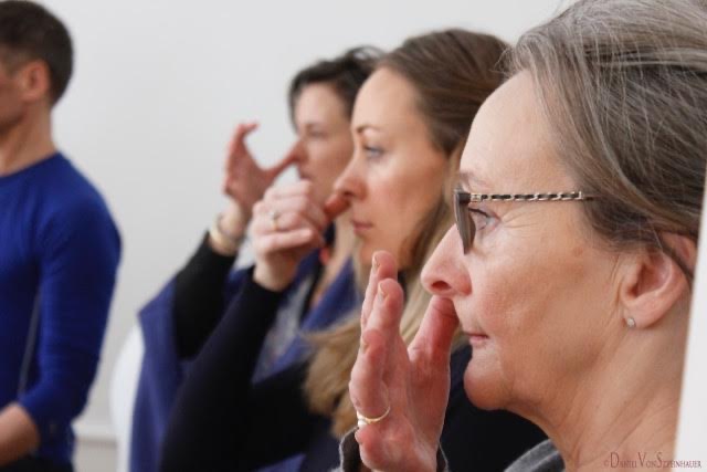 Participants in a guided breathing practice